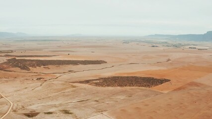 Wall Mural - Nature, landscape and drone of desert for natural environment, dry ecosystem and ecology. Sustainability, countryside and aerial view of mountains, sand and terrain for rural travel destination