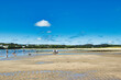 © iSky Media - Sunny Beach Day with People Enjoying the Water in Cornwall, UK