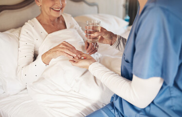 Poster - Nurse, senior woman and hands for pills in home, antibiotics treatment and water to help with drugs. Caregiver, elderly person and relax in bed with medicine, tablets and volunteer to support patient