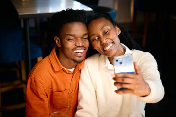 A African couple taking a photo together