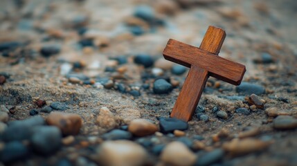 Wall Mural - A simple wooden cross laying on a rock, surrounded by small pebbles. Focus on the cross and texture of the rocks. No people.