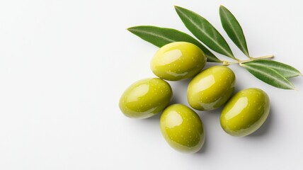 A bunch of green olives are on a white background