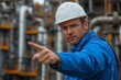 © Nataliia_Trushchenko - A man in a blue jacket and white hat points to something. He is wearing a hard hat and safety gear
