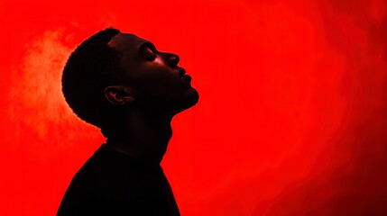 Poster - Silhouette of a pensive man against a red background 