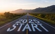 © StreamPixel - A photo of a long, straight road stretching into the distance, with the words '2025 START' boldly painted in white capital letterson the asphalt.