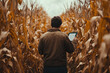 © Valeryi - Farmer using tablet computer in corn field. Technology and agriculture concept.