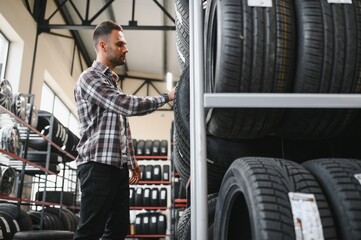 A male customer in a car tire shop