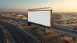 © theerachai - Blank Billboard in Desert Landscape with Highway at Sunset