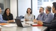 © sungedi - Diverse team of professionals laughing and discussing around a conference table