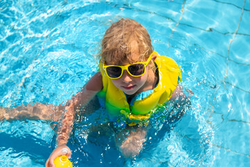 Child playing in the pool. Selective focus.