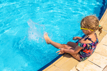 Poster - Child playing in the pool. Selective focus.