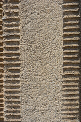 Detail of exterior wall with beige rough facade