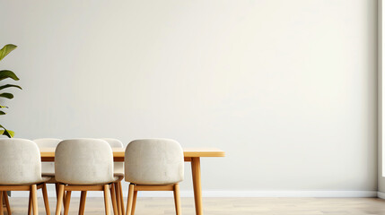 Photo of a minimalist dining room with a wooden table and chairs against a beige wall. There is a potted plant in the corner of the room. The room is bathed in soft natural light.