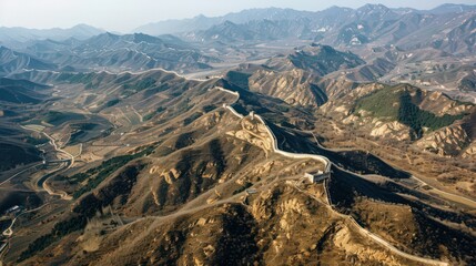 Wall Mural - An aerial view of the Great Wall as it traverses diverse landscapes, from steep mountain ridges to serene valleys,