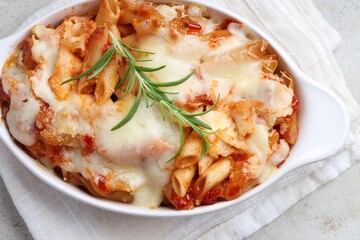 Delicious al forno pasta in baking dish on light table, top view