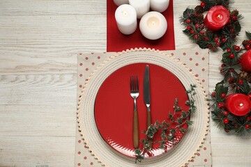 Wall Mural - Christmas place setting with plate, cutlery and festive decor on wooden table, flat lay