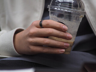 Young boy holding a plastic coffee cup