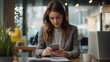 © sungedi - Woman in a Grey Blazer Using Her Smartphone at a Desk in an Office
