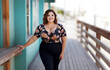 © MonkaLemonka - happy, cheerful, full of energy brunette woman in floral blouse and black bottom outside; copy space
