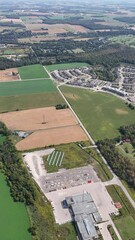 Wall Mural - Aerial footage of a residential district and green fields in a rural village near Kitchener, Canada