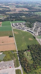 Wall Mural - Aerial footage of a residential district and vast green fields in Kitchener city, Ontario, Canada