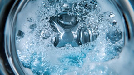 Washing machine interior with water splashing and bubbles. Laundry and cleaning concept.