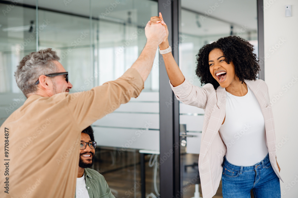 Supportive Colleag A high-five moment captures the joyful success within a team, as a ...
