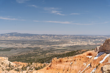 A beautiful view of Hoodoos with greenery and red rocks in Bryce Canyon, Utah.