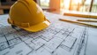 © paisorn - Blueprint floor plan architectural project on the table with yellow helmet and pencil