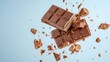 © Panisara - Highspeed shot of a chocolate bar breaking in half, with crumbs and chunks of chocolate flying in different directions