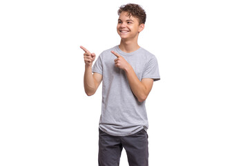 A smiling teenage boy in a gray T-shirt pointing in both directions, isolated on white background.