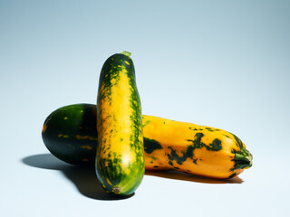 Wall Mural - Organic zucchini over blue background