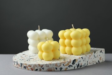 Wall Mural - Beautiful colorful bubble candles on grey table