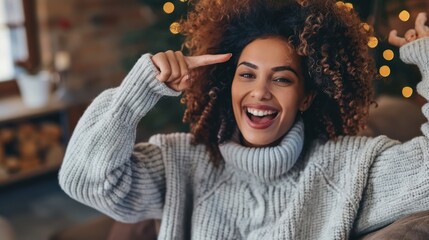 Wall Mural - A woman with curly hair is smiling and pointing her finger