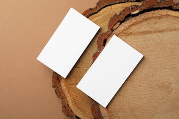 Wall Mural - Blank business cards on brown background, flat lay. Mockup for design