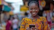 © Charoen - A woman is smiling and holding a cell phone