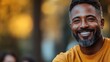 © Charoen - A man with a beard and a smile is wearing a yellow shirt