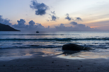 Wall Mural - Beau Vallon Beach landscape with wet coastal sand and silhouettes