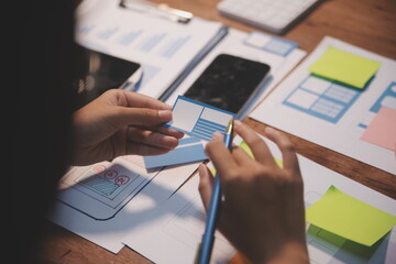 The designer team is designing the uxui system to make the uxui system work well on new phones and support system updates. Website development concept UI UX front end designer