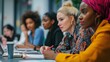 © sungedi - Diverse group of women collaborating and taking notes at a work meeting