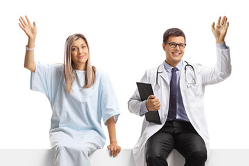 Canvas Print - Male doctor and a female patient sitting on a blank panel and waving