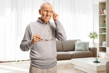 Sticker - Elderly man with headache holding glasses and his forhead