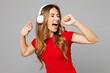 © ViDi Studio - Young expressive singer happy woman wear red t-shirt casual clothes listen to music in headphones sing song in microphone at karaoke club isolated on plain grey background studio. Lifestyle concept.