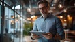 © sungedi - A businessman in a modern office uses a tablet device