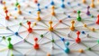 © rookielion - Colorful pins connected by strings on a white surface, showcasing a network of relationships and connections.