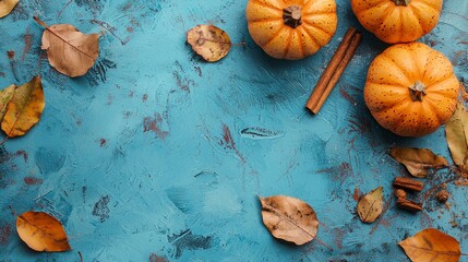 Wall Mural - This blue background has pumpkins, leaves, and cinnamon on it.