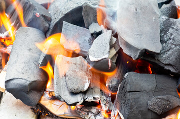 Barbecue Grill Pit With Glowing And Flaming Hot Charcoal Briquettes, Close-Up