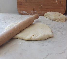 the baking dough is laid out on a board