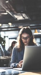 Wall Mural - Young woman working on laptop in modern office.