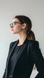 © Felippe Lopes - Young woman in a black blazer looks thoughtfully to the side.